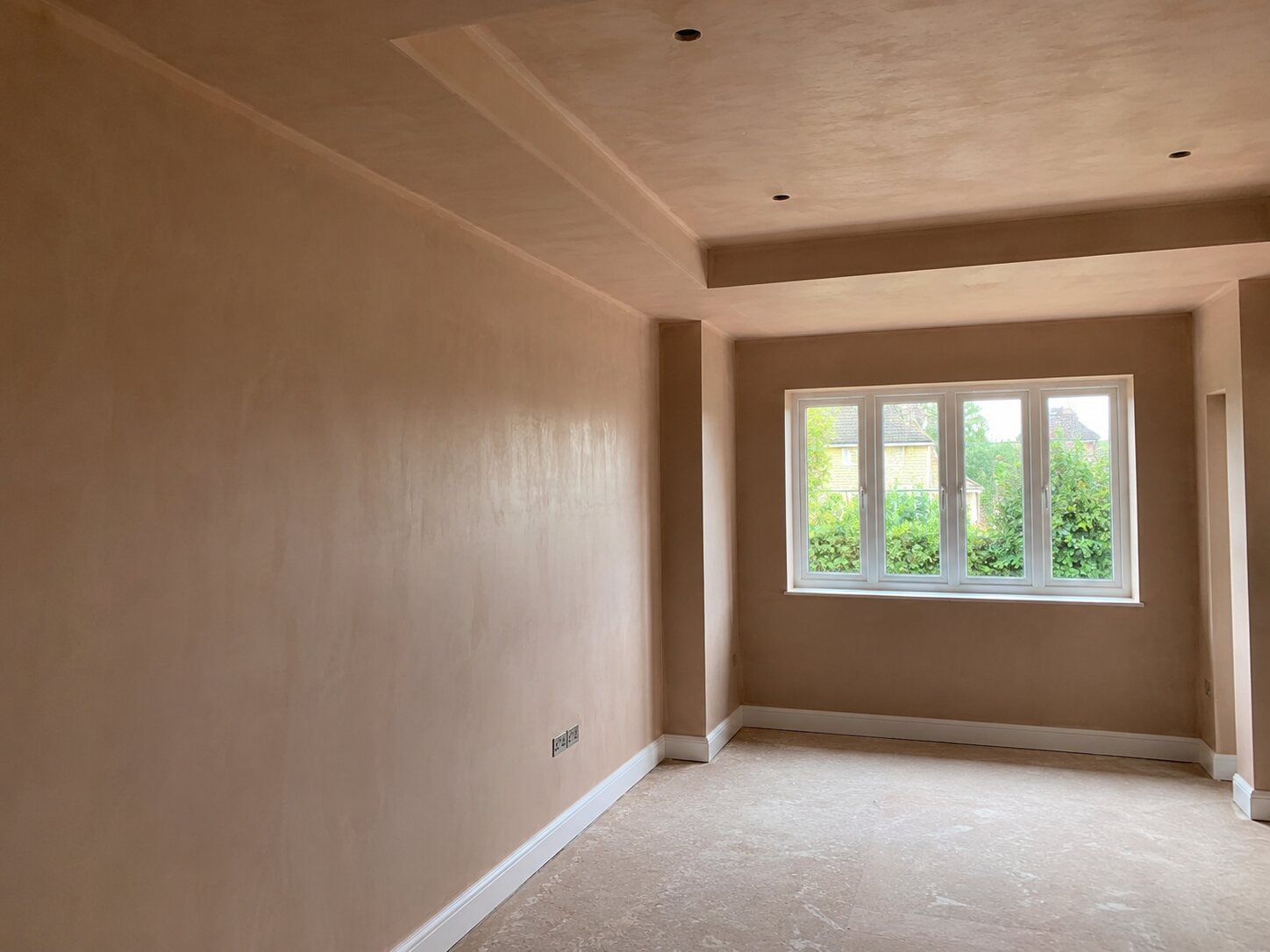 Freshly plastered living room with detailed ceiling work