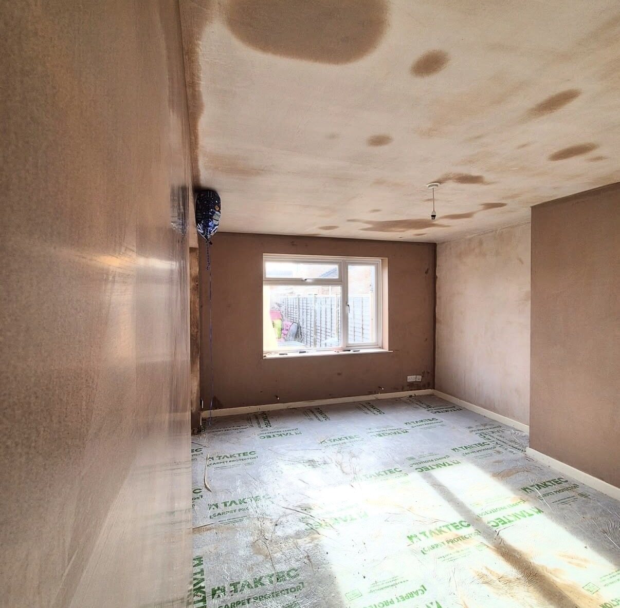 Freshly plastered room with protective floor covering